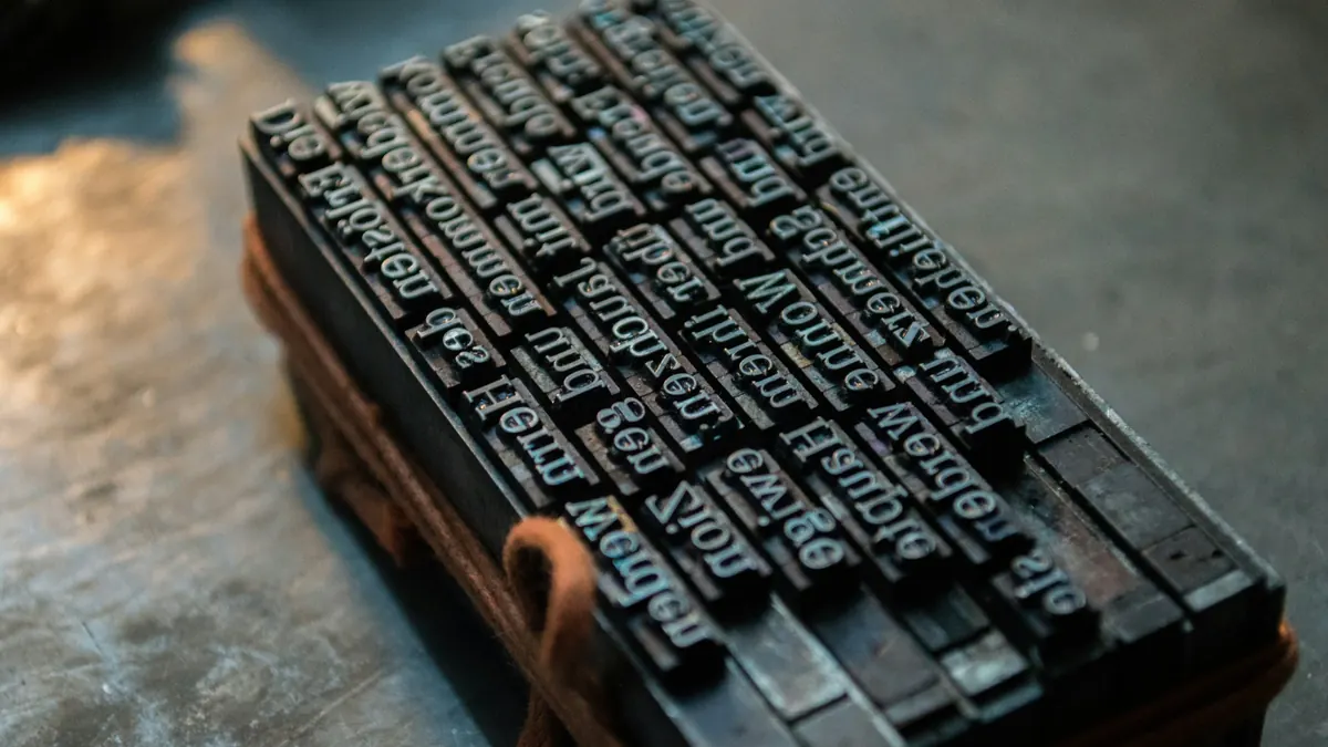 A block of old metal printing type set in lines and tied with string