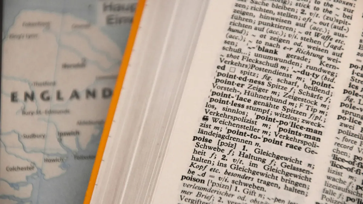 A German-English dictionary lying open on a map of eastern England
